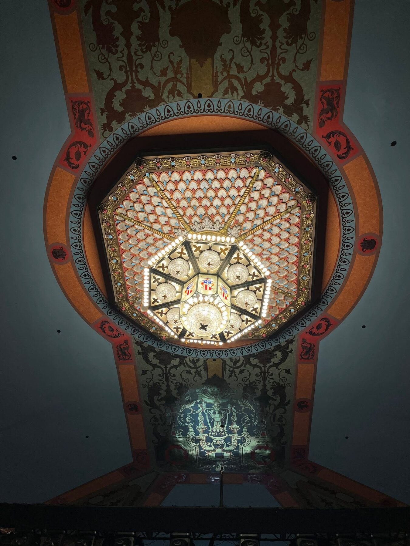 The restored chandelier and painted auditorium ceiling viewed from below