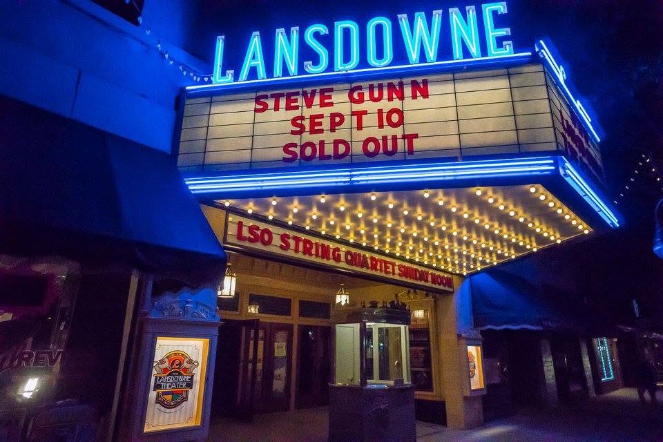 The marquee lit at night, sold-out show on the board